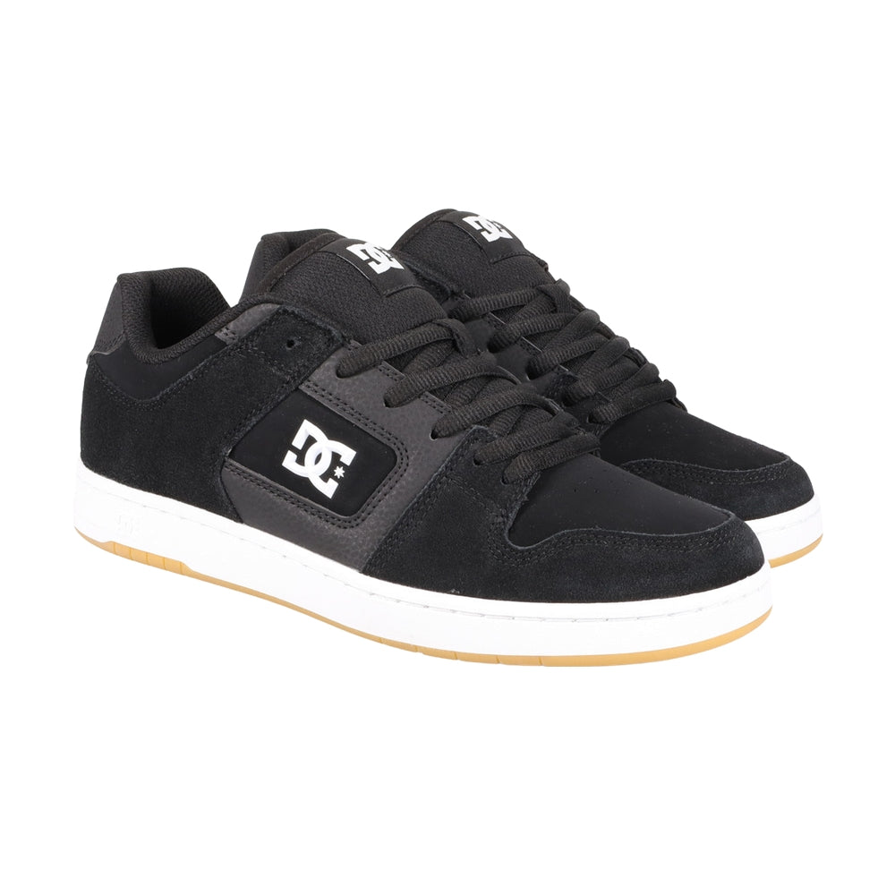 A pair of black DC shoes with white soles.