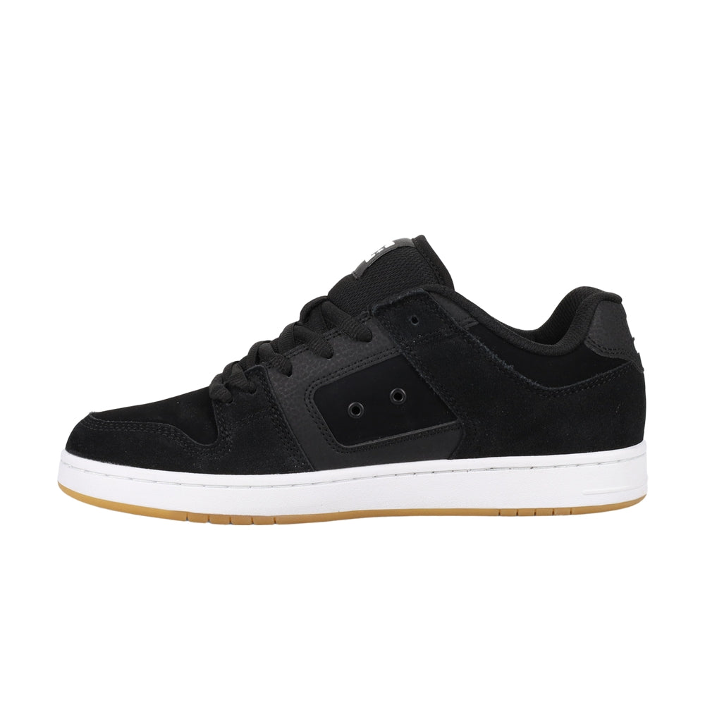 A black DC shoe with white soles.