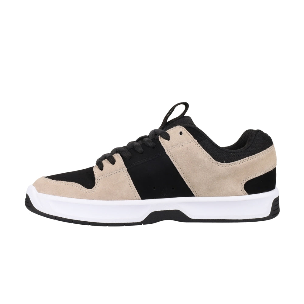 A beige and black shoe with white soles.