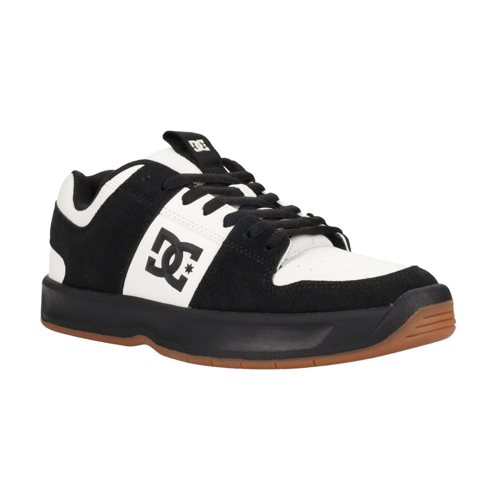 A black and white DC shoe with black soles.