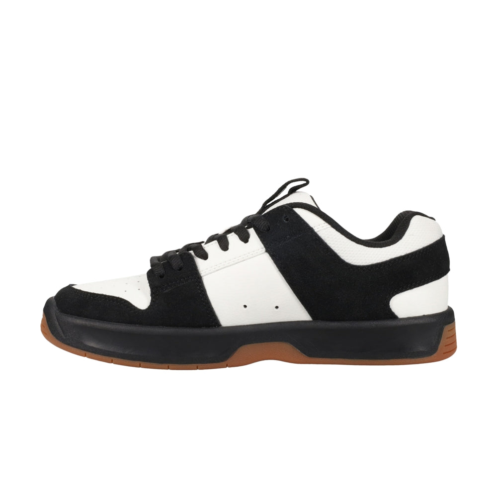 A black and white DC shoe with black soles.