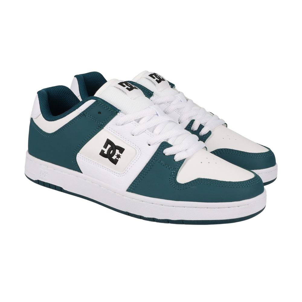 A pair of white DC shoes with green highlights.