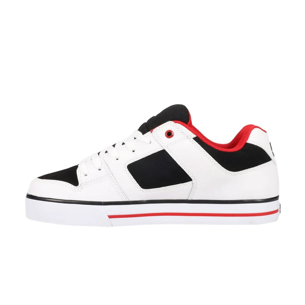 A white DC shoe with black and red highlights.
