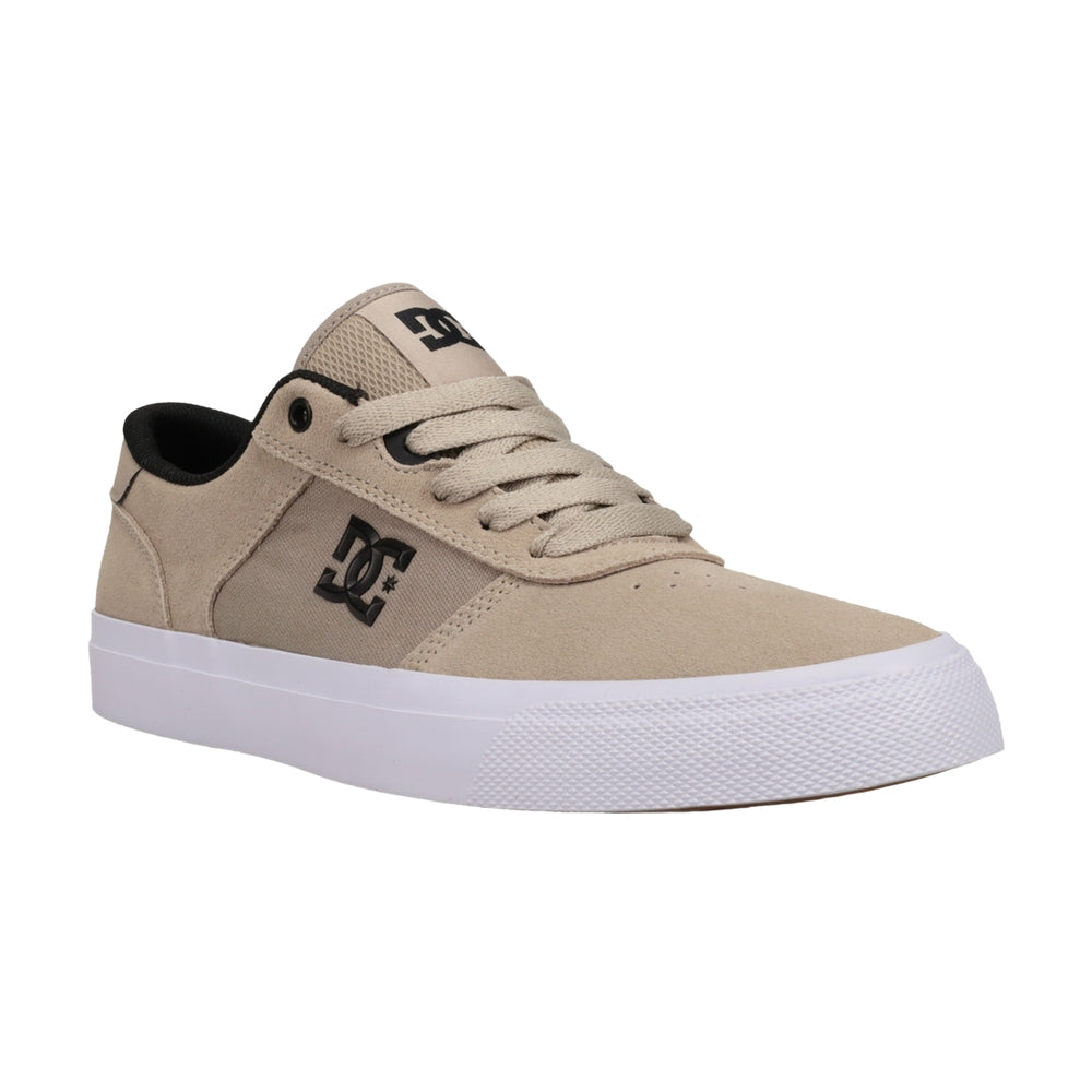 A brown DC shoe with white soles.