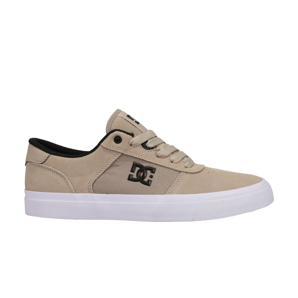A brown DC shoe with white soles.