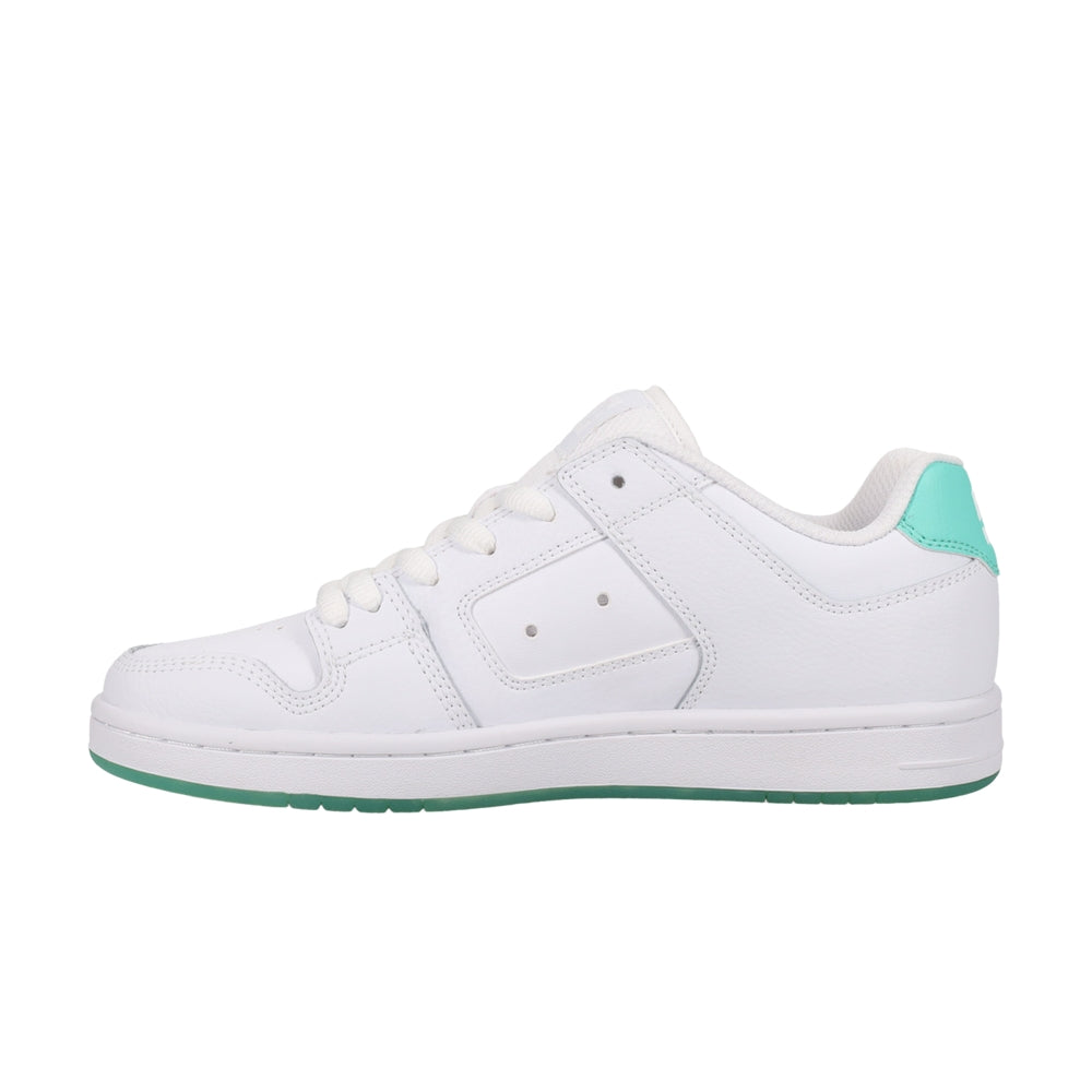 A white DC shoe with green soles.