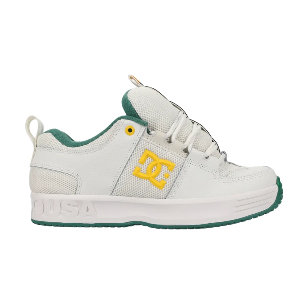 A white DC shoe with green soles.
